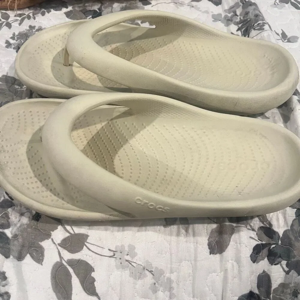 Crocs Mellow Flip sandals feature a thick, comfortable footbed designed for reco